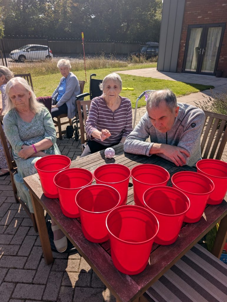 a group of residents playing table basket ball game