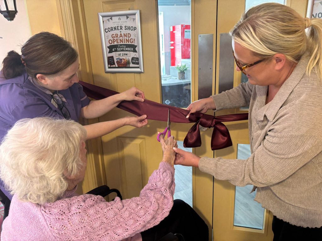 resident cuts the ribbon to officially open Astley View's corner shop 
